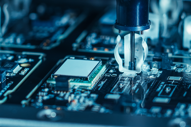Semiconductor Industry Close-up of Electronic Factory Machine at Work: Printed Circuit Board Being Assembled with Automated Robotic Arm