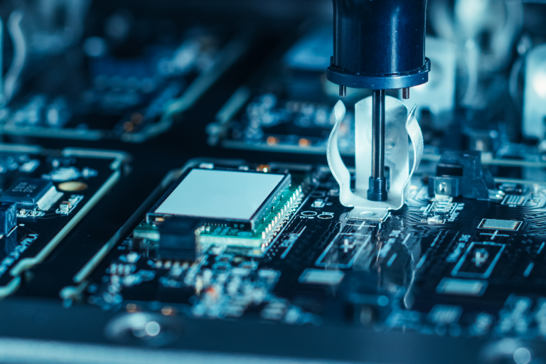 Close-up of Electronic Factory Machine at Work: Printed Circuit Board Being Assembled with Automated Robotic Arm